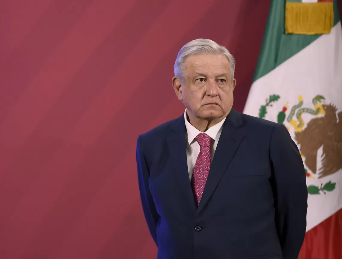 Mexican President Andres Manuel Lopez Obrador stands next to the Mexican flag before his daily press conference at the Palacio Nacional in Mexico City on December 8, 2020. - The Mexican government presented its vaccination plan against the Covid-19. (Photo by ALFREDO ESTRELLA / AFP) (Photo by ALFREDO ESTRELLA/AFP via Getty Images)