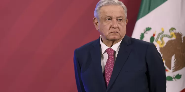 Mexican President Andres Manuel Lopez Obrador stands next to the Mexican flag before his daily press conference at the Palacio Nacional in Mexico City on December 8, 2020. - The Mexican government presented its vaccination plan against the Covid-19. (Photo by ALFREDO ESTRELLA / AFP) (Photo by ALFREDO ESTRELLA/AFP via Getty Images)
