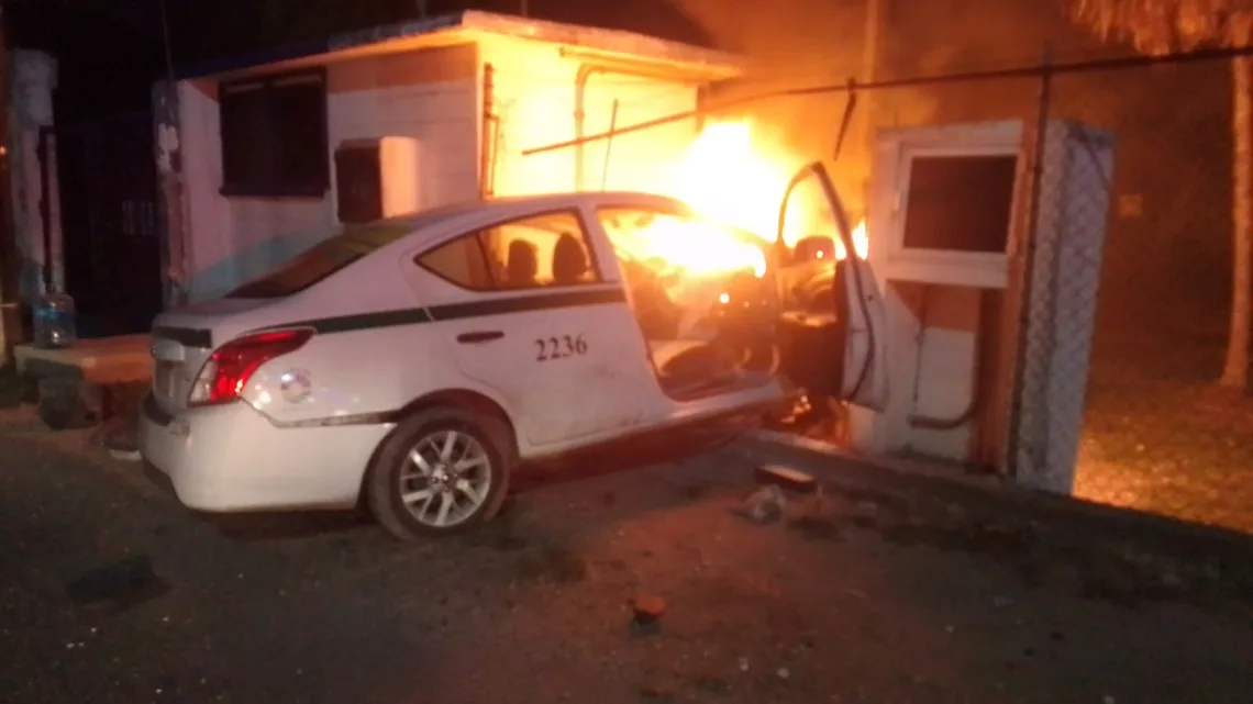 Taxi arde junto a cárcamo tras impacto; conductor es retirado con lesiones