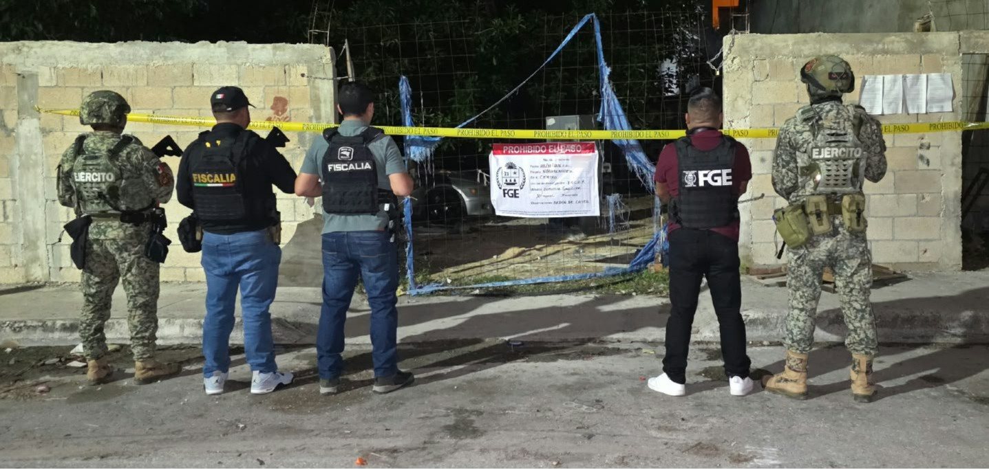 Agentes de la Fiscalía y del Ejército frente a un inmueble con sellos de aseguramiento