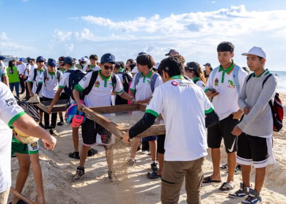 Estudiantes del CECyTE criban arena durante la limpieza costera en Playa del Carmen