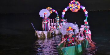 Catrinas en canoas iluminadas durante el festival Tradición, Luz y Reencuentro en Cozumel